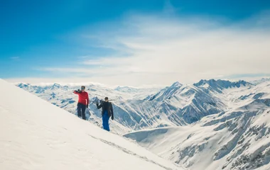 A man and a woman walking on a beach with palm trees