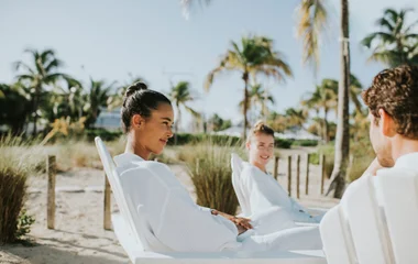 people hanging out on beach in robes