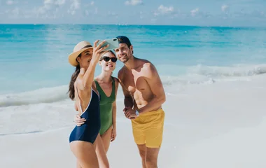friends taking photo on beach