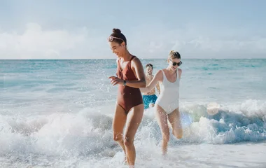 friends running on beach in turks and caicos