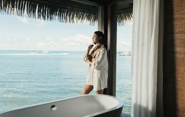 A beach with turquoise water and palm trees