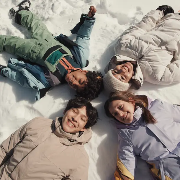A group of teenagers having fun in the snow