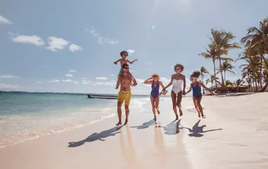 family on a walk on the beach in the sun