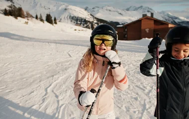 Criança com equipamento de esqui em montanha nevada