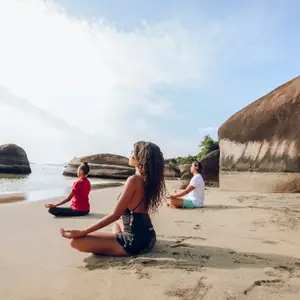pessoas a beira-mar meditando