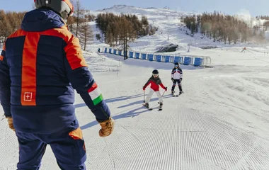 duas crianças esquiando na neve
