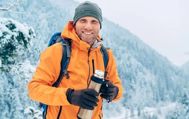 Homem usando uma soft shell jacket laranja.