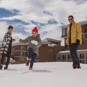 family playing in the snow
