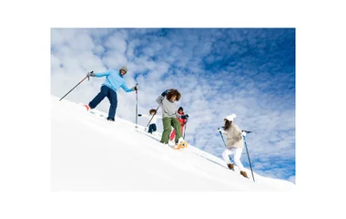 family snow-shoeing in the snow