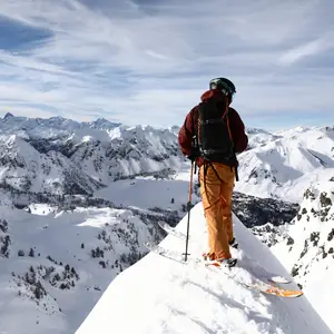 man at the top of a snowy mountain