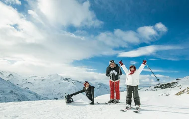 Família curte uma viagem de esqui rodeados de neve.