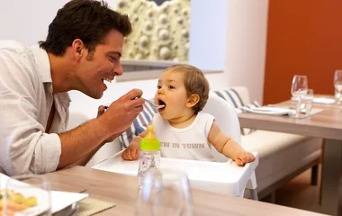 Man feeding a baby