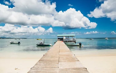 Pontoon leading to a boat on the beach
