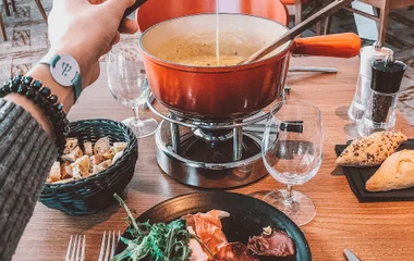 A man and a woman walking on a beach with palm trees