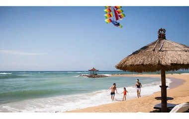 Family flying a kite at the beach