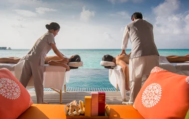 Couple enjoying a massage from two masseuses in their private terrace
