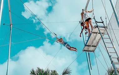 Young boy in the air on the flying trapeze
