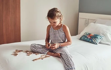 child playing on bed in club med