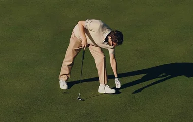 Sporty man playing golf in Club Med