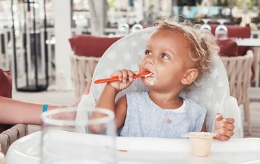 child eating in a restaurant in club med