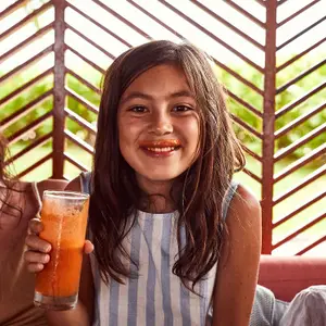child at club med enjoying a cold drink