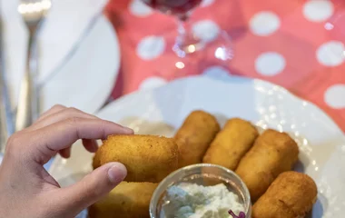 A man and a woman walking on a beach with palm trees