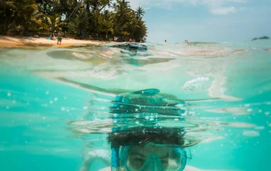 boy snorkeling in coral island, phuket