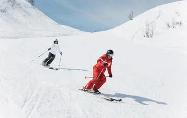esf instructor and a student skiing down a slope