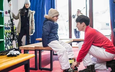kid trying on ski equipment