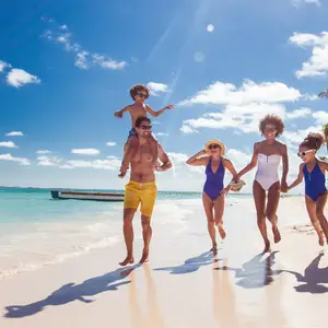 Family running on the beach in the Caribbean