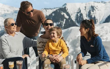 Multi generation family enjoying the mountain sitting outside