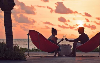 Couple drinking champagne at sunset