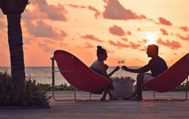 Couple at sunset champagne glasses