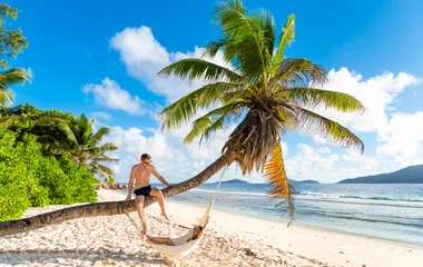 Newlyweds relaxing on a Seychelles beach