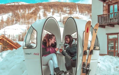 two friends sharing a hot drink in the Italian Alps