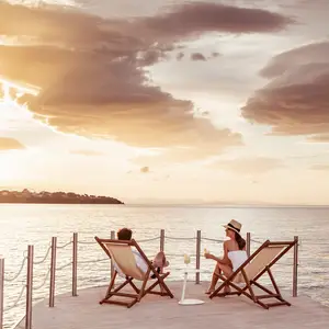 couple on the deck watching the sun set in Sicily