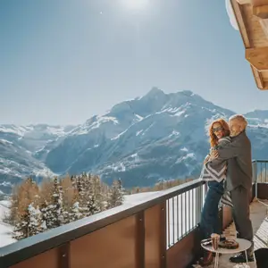 Couple on the balcony with views of the Alps