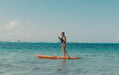 paddle boarding on the ocean on holiday