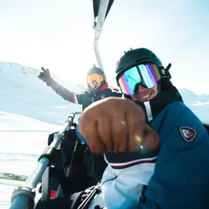 Riding on a ski chair lift on the slopes