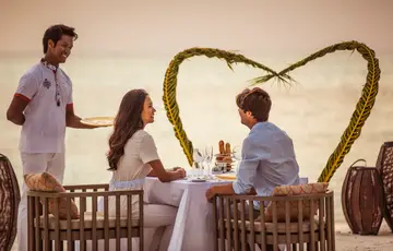 Couple enjoying a romantic dinner in the Maldives