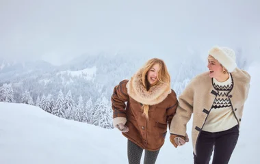 Duas pessoas sorridentes na neve.