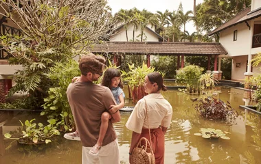 a family in front of the Club Med phuket resort
