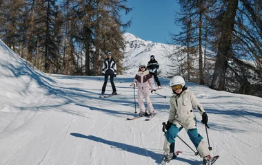 A family skiing together during winter
