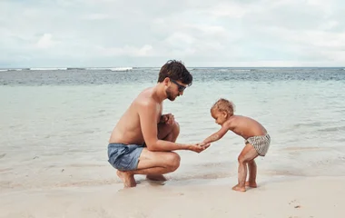 Father and baby on the beach