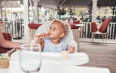 Baby eating food on holiday
