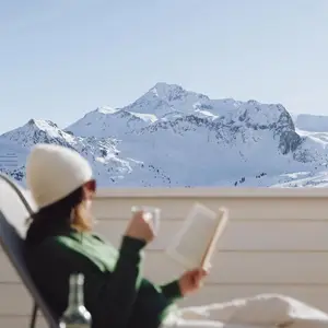 lady relaxing on a lounger in the alps