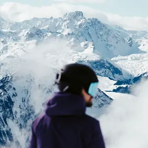 Man skiing with the European Alps in the background