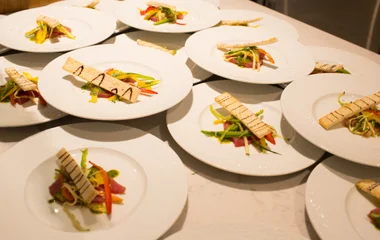 Platos superpuestos con ensalada y tostadas.