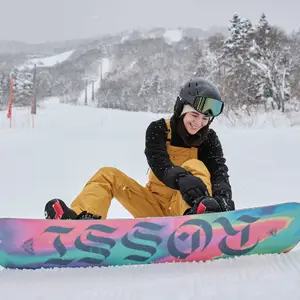 Women with snowboard sitting on the snow.