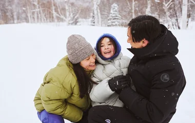 Family at the snow with winter clothes.
